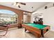 Spacious game room with a pool table, a large window, and neutral tile flooring at 205 E Irvine Rd, Phoenix, AZ 85086