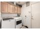 Well-equipped laundry room with ample cabinet space and modern washer and dryer units at 205 E Irvine Rd, Phoenix, AZ 85086