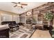 Inviting living room featuring a stone fireplace, rustic wood wall accents, and comfortable seating at 205 E Irvine Rd, Phoenix, AZ 85086