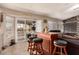 Bright living room with bar seating, a sliding glass door to the outdoor deck, and comfortable seating at 205 E Irvine Rd, Phoenix, AZ 85086