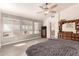 Bright main bedroom with large windows and a dresser with a mirror at 205 E Irvine Rd, Phoenix, AZ 85086