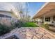 Inviting backyard with stone patio, lush lawn, and covered dining area, ideal for outdoor living and entertaining at 2125 W Berridge Ln, Phoenix, AZ 85015