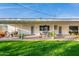 Spacious covered patio with string lights, offering a great spot for outdoor dining and entertaining at 2125 W Berridge Ln, Phoenix, AZ 85015