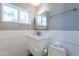 Well-lit bathroom with modern fixtures, white vanity, and a tiled backsplash at 2125 W Berridge Ln, Phoenix, AZ 85015