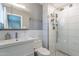 Modern bathroom featuring a sleek vanity, toilet, and tiled shower with glass doors at 2125 W Berridge Ln, Phoenix, AZ 85015