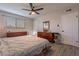 Bright bedroom with ceiling fan, wood flooring, and a window for natural light at 2125 W Berridge Ln, Phoenix, AZ 85015