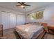 Bedroom with wood flooring, large window, and a ceiling fan for added comfort at 2125 W Berridge Ln, Phoenix, AZ 85015