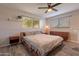 Bright bedroom with ceiling fan, wood flooring, and a window for natural light at 2125 W Berridge Ln, Phoenix, AZ 85015