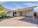 Spacious covered carport attached to a charming home with a well-manicured yard at 2125 W Berridge Ln, Phoenix, AZ 85015