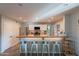 Bright and open kitchen with modern cabinets, stainless steel appliances, a breakfast bar, and stylish backsplash at 2125 W Berridge Ln, Phoenix, AZ 85015