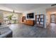 Bright and spacious living room with wood-look tile flooring, large windows, and stylish decor at 2125 W Berridge Ln, Phoenix, AZ 85015