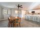 Open-concept living and dining area featuring modern lighting, tile flooring, and a convenient breakfast bar at 2125 W Berridge Ln, Phoenix, AZ 85015