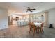 Inviting open-concept living space featuring wood-look tile flooring, a ceiling fan, and seamless flow to kitchen at 2125 W Berridge Ln, Phoenix, AZ 85015