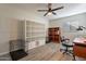 Bright home office featuring modern desk, open shelving, and stylish decor for a productive workspace at 2125 W Berridge Ln, Phoenix, AZ 85015