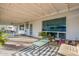 Covered patio featuring stylish seating, string lights, and a view of the backyard, creating a relaxing outdoor space at 2125 W Berridge Ln, Phoenix, AZ 85015