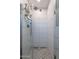 Modern shower with white tile walls, glass door, and a stylish showerhead at 2125 W Berridge Ln, Phoenix, AZ 85015