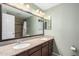 Spacious bathroom featuring dual sinks, granite countertops, and a large mirror and sconce lighting at 2129 N Apollo Ct, Chandler, AZ 85224