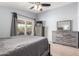 Spacious bedroom with sliding glass doors and stylish gray furniture set, including a dresser and nightstand at 2129 N Apollo Ct, Chandler, AZ 85224