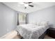 Comfortable bedroom with ceiling fan, window, neutral carpet, and a large bed featuring patterned bedding at 2129 N Apollo Ct, Chandler, AZ 85224