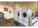 Bright and practical laundry area with modern washer and dryer, adjacent to the garage entrance at 2129 N Apollo Ct, Chandler, AZ 85224