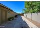 Backyard featuring a long, concrete driveway with a side storage area and gated exit at 2217 N 37Th Pl, Phoenix, AZ 85008