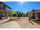 Large backyard with an open patio and desert landscaping is covered with a canvas shade and string lights at 2217 N 37Th Pl, Phoenix, AZ 85008