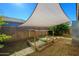 Sunlit backyard featuring raised garden beds and a shade canopy for growing vegetables at 2217 N 37Th Pl, Phoenix, AZ 85008