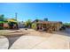 Spacious backyard featuring a canvas shade, patio with seating, desert landscaping, and mature trees at 2217 N 37Th Pl, Phoenix, AZ 85008