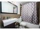 Updated bathroom with tiled walls, modern sink, and stylish shower curtain at 2217 N 37Th Pl, Phoenix, AZ 85008