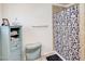 Light and airy bathroom with a patterned shower curtain, cabinet, and ample storage at 2217 N 37Th Pl, Phoenix, AZ 85008