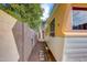 Exterior shot of a well-maintained camper nestled beside a gravel path, with a wall and greenery at 2217 N 37Th Pl, Phoenix, AZ 85008