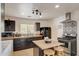 A charming kitchen with black cabinets, stainless steel appliances, and a butcher block island at 2217 N 37Th Pl, Phoenix, AZ 85008