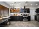 Modern kitchen featuring sleek black cabinets, stainless steel appliances, and herringbone wood floors at 2217 N 37Th Pl, Phoenix, AZ 85008