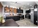 Modern kitchen featuring sleek black cabinets, stainless steel appliances, and herringbone wood floors at 2217 N 37Th Pl, Phoenix, AZ 85008