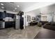 Open-concept living space featuring herringbone floors, a modern kitchen, and unique wall art at 2217 N 37Th Pl, Phoenix, AZ 85008