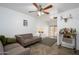 Cozy living room with a ceiling fan, herringbone floors, and a stylish bar cart at 2217 N 37Th Pl, Phoenix, AZ 85008