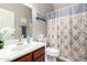 Bathroom with a patterned shower curtain and single sink vanity, creating a cozy ambiance at 23510 N 25Th St, Phoenix, AZ 85024