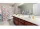 Bathroom showcasing a double-sink vanity and patterned shower curtain creating a welcoming atmosphere at 23510 N 25Th St, Phoenix, AZ 85024