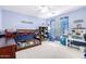 Blue bedroom features bunk bed, colorful curtains, built-in shelves, and neutral carpet at 23510 N 25Th St, Phoenix, AZ 85024