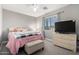 Bright bedroom featuring a ceiling fan and a chest of drawers at 23510 N 25Th St, Phoenix, AZ 85024