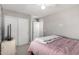 Neutral bedroom with a ceiling fan, closet, and a bed covered with a pink comforter at 23510 N 25Th St, Phoenix, AZ 85024