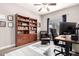 Inviting home office featuring a wooden bookcase, comfortable chair, ceiling fan, and a well-lit workspace with large monitor at 23510 N 25Th St, Phoenix, AZ 85024