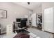 Functional home office featuring a desk with dual monitors, file cabinet, and closet storage, providing an organized workspace at 23510 N 25Th St, Phoenix, AZ 85024