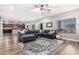 Large living room featuring hardwood floors, a comfy couch, and an adjacent dining area at 23510 N 25Th St, Phoenix, AZ 85024