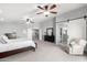 Large primary suite featuring carpet, ceiling fans, and a decorative barn door at 23510 N 25Th St, Phoenix, AZ 85024