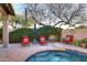 Backyard features refreshing pool, patio seating, and lush desert landscaping, perfect for outdoor relaxation at 24024 N 74Th St, Scottsdale, AZ 85255