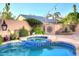 A backyard features a pool, a spa, and desert landscaping, creating a serene retreat for relaxation and enjoyment at 24024 N 74Th St, Scottsdale, AZ 85255