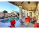 Outdoor oasis featuring a refreshing pool, covered patio, and comfortable seating for relaxation and entertainment at 24024 N 74Th St, Scottsdale, AZ 85255