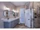 Modern bathroom featuring double sinks, a sleek vanity, and a large glass-enclosed shower at 24024 N 74Th St, Scottsdale, AZ 85255