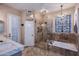 Elegant bathroom featuring double sinks, a large shower, and a separate soaking tub with natural light at 24024 N 74Th St, Scottsdale, AZ 85255